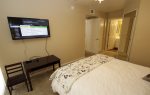 Master bedroom with wall mounted flat screen TV